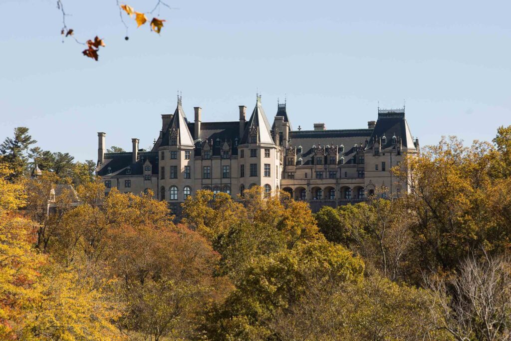 view of the biltmore estate in the fall from the lagoon