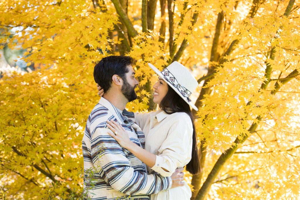 bright fall foliage surrounds a couple at the biltmore estate