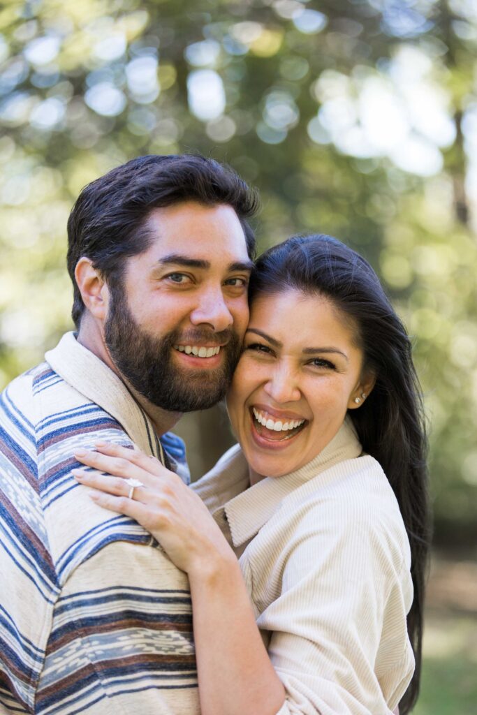 closeup photo of a happy couple grinning after their surprise proposal at the biltmore estate