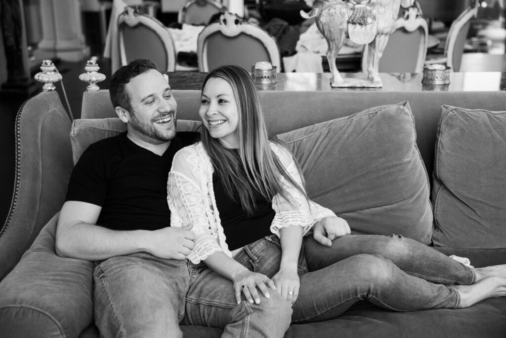 couple cuddles on the couch at their airbnb the evening before their north carolina elopement