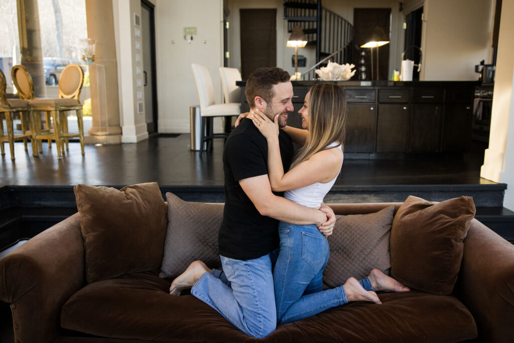 couple cuddles on the couch at their airbnb