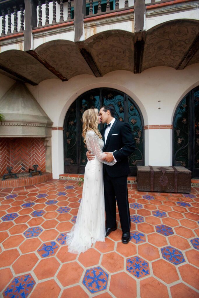 couple kissing on their wedding day at malibu's adamson house