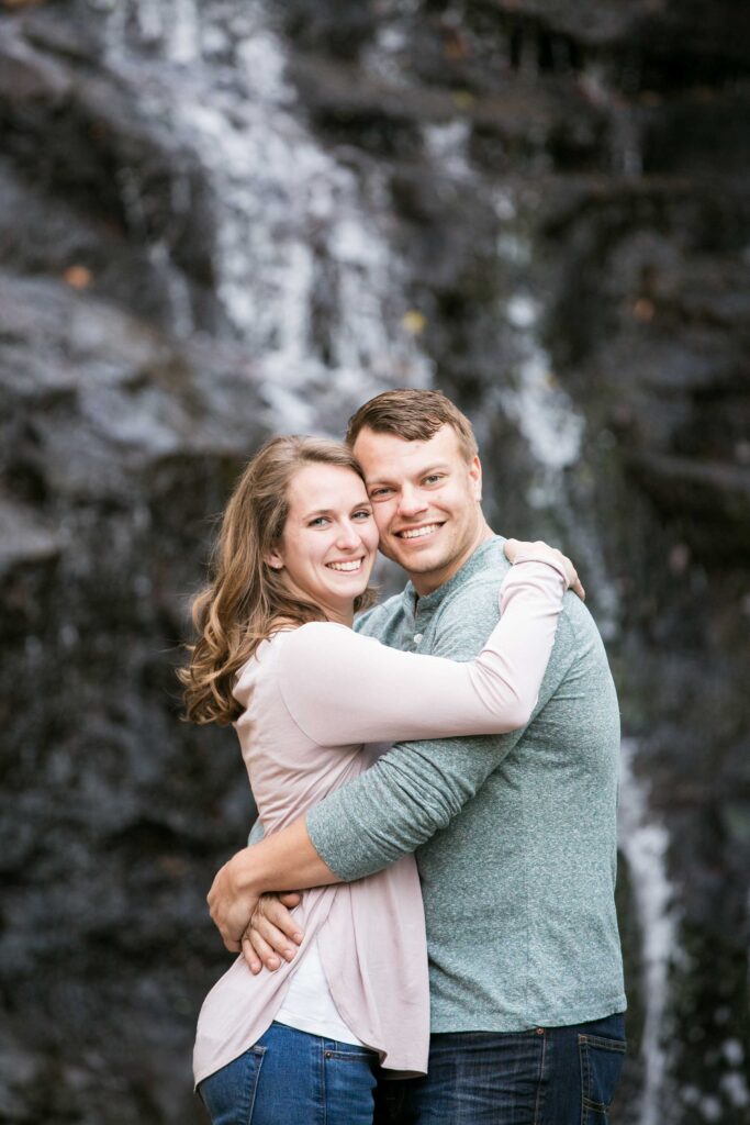 engaged couple at waterfall in Hanging Rock State Park in nc