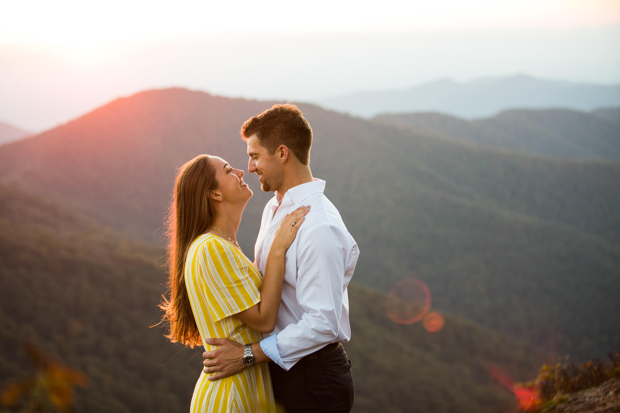 couple embracing at golden hour at craggy gardens during their engagement session