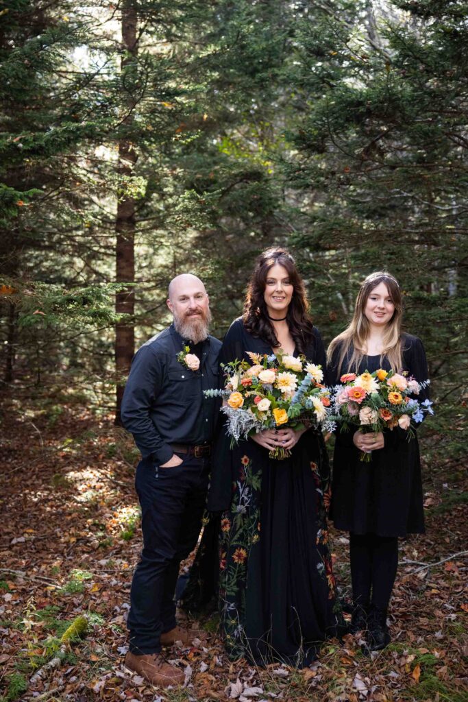 eloping couple with their daughter wearing all black wedding attire for their grayson highlands elopement