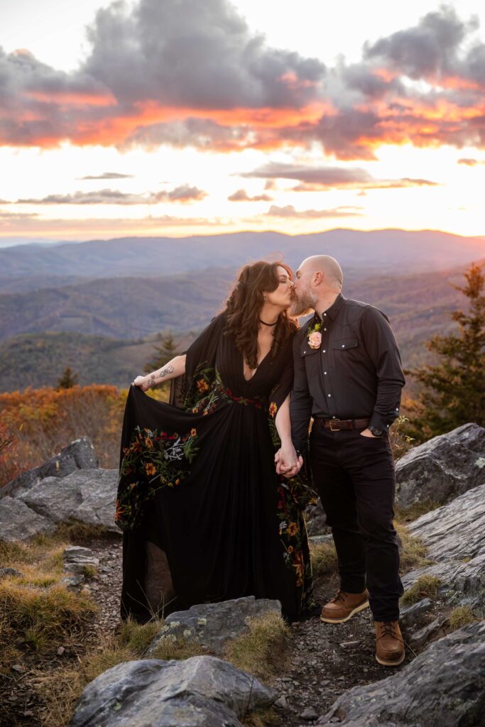 Bride and groom kissing on a ridge at sunset during their fall elopement at Grayson Highlands State Park Virginia.