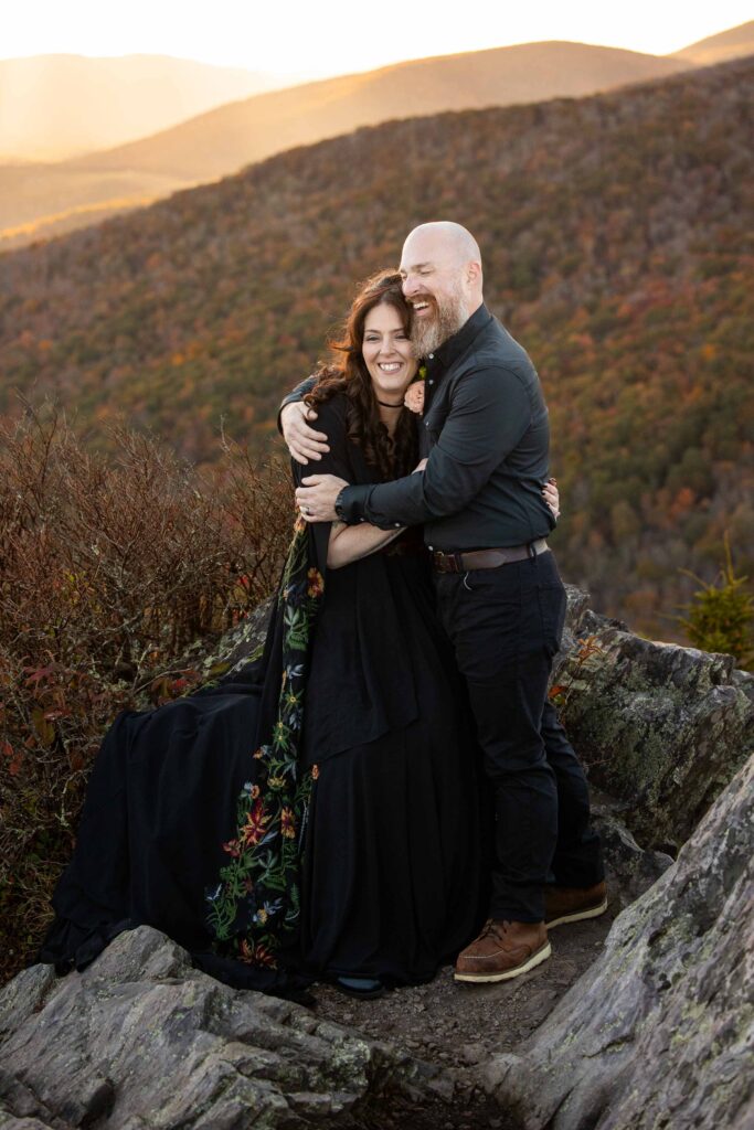 Bride and groom standing on a ridge at sunset during their fall elopement at Grayson Highlands State Park Virginia.