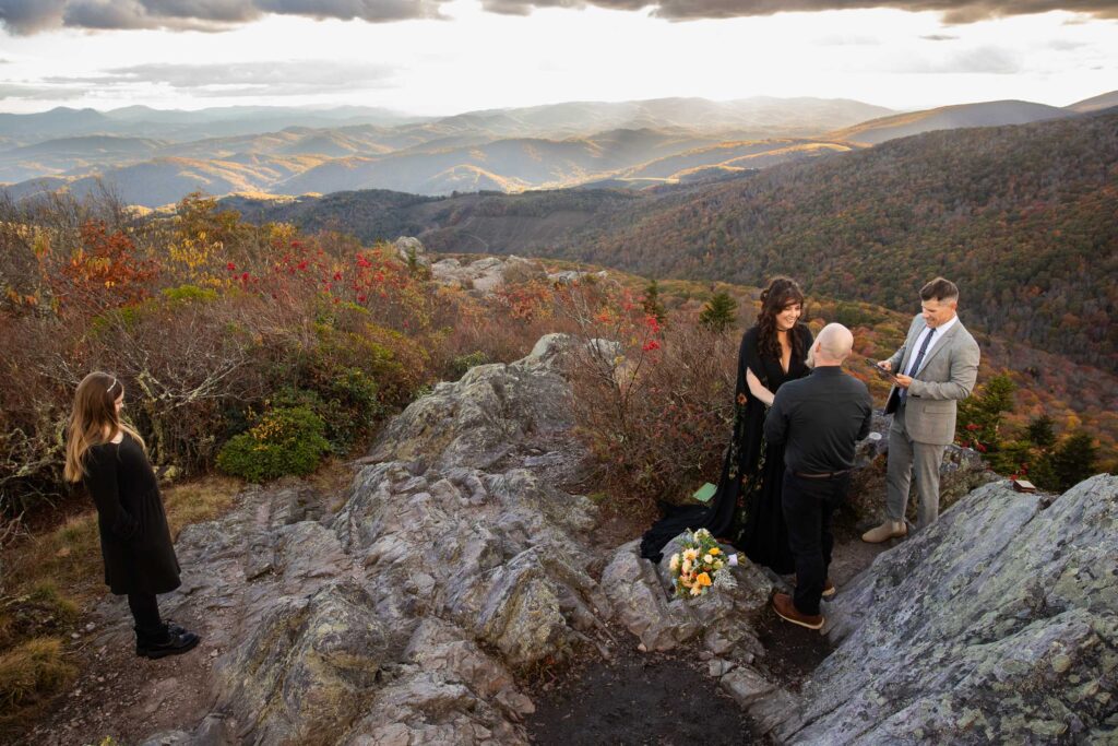 Couple exchanging handwritten vows during a mountain elopement at Grayson Highlands State Park VA.