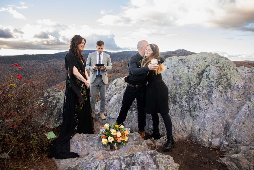 Stepdad reading special vows and giving a gift to his new stepdaughter during a family elopement ceremony at Grayson Highlands State Park.
