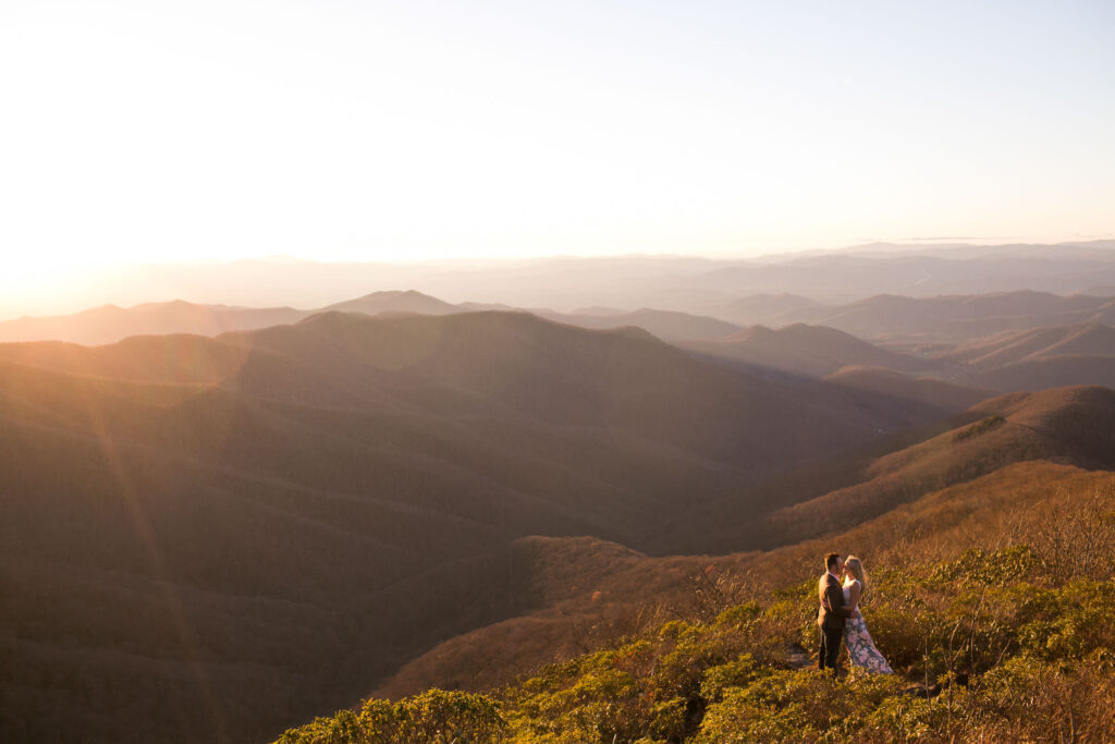 couple with a wide open mountain view during their engagement session at craggy gardens on the blue ridge parkway