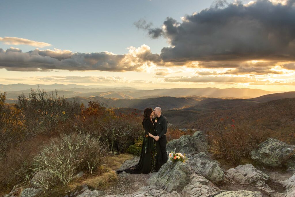 eloping couple kissing at sunset at grayson highlands state park