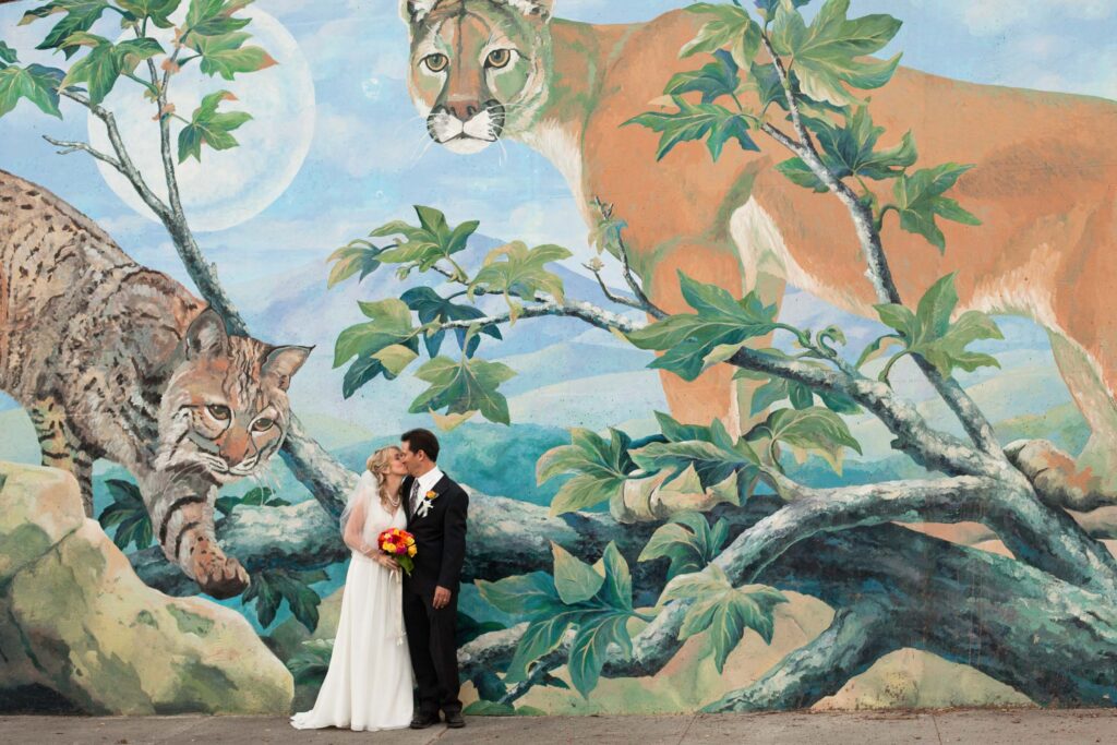 wedding couple in front of a mural in malibu, ca