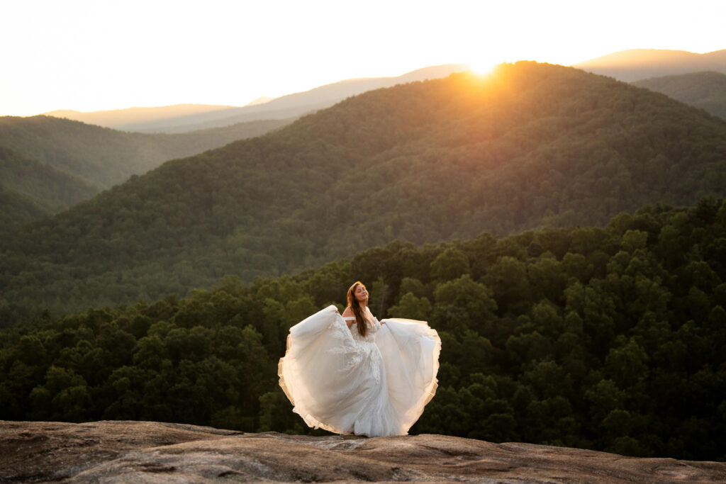 bride dancing on a mountaintop at sunset in nc at a state park