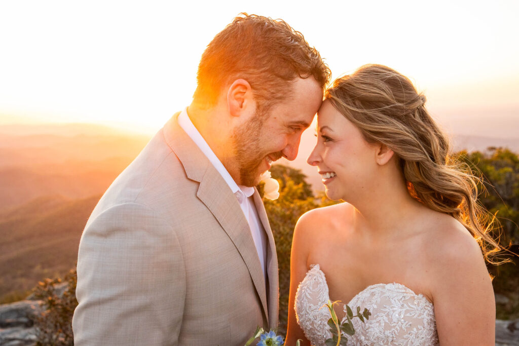 couple canoodling during their elopement in nc at sunrise