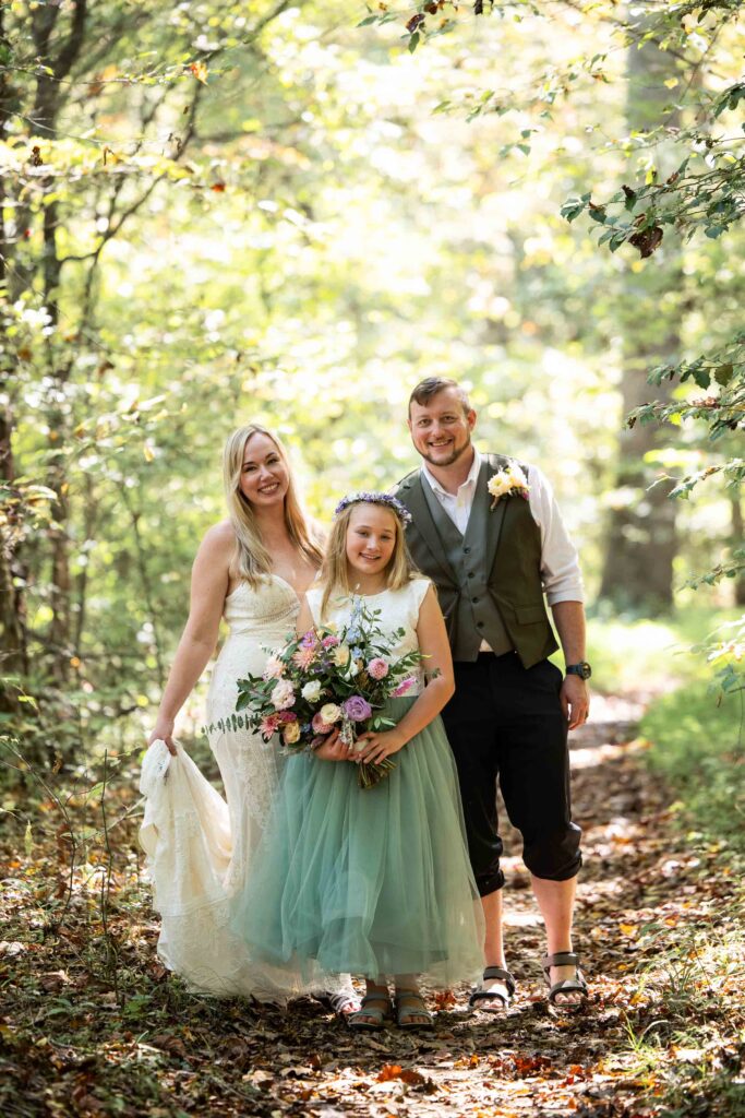 Bride, groom, and daughter during an intimate NC river elopement at Pilot Mountain
