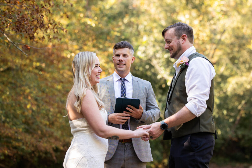 Pilot Mountain State Park elopement on the Yadkin River in North Carolina with a couple standing on river rocks surrounded by trees