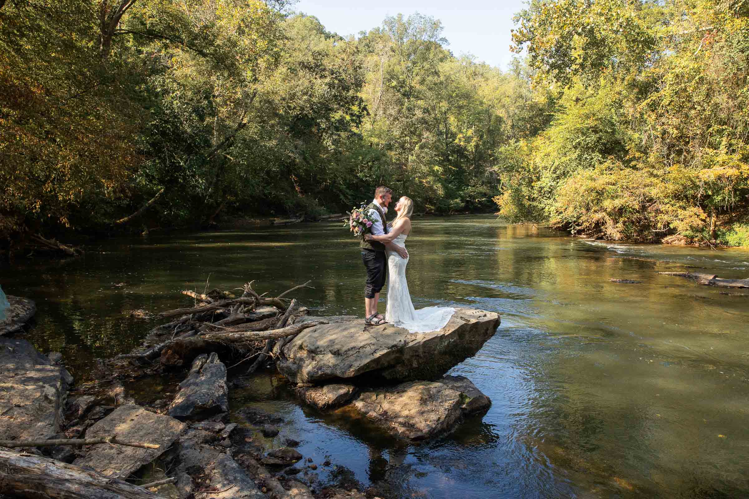 NC adventure elopement with a couple walking along the Yadkin River at Pilot Mountain