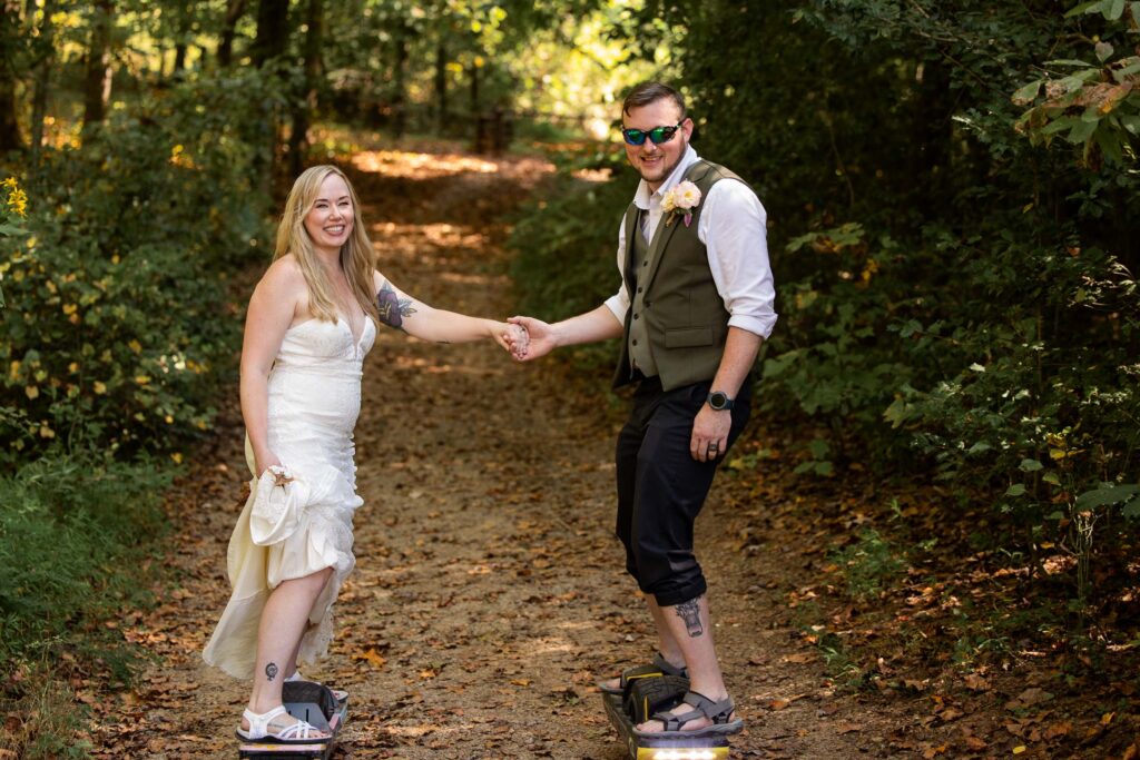 Couple riding Onewheels during their Pilot Mountain State Park elopement in North Carolina