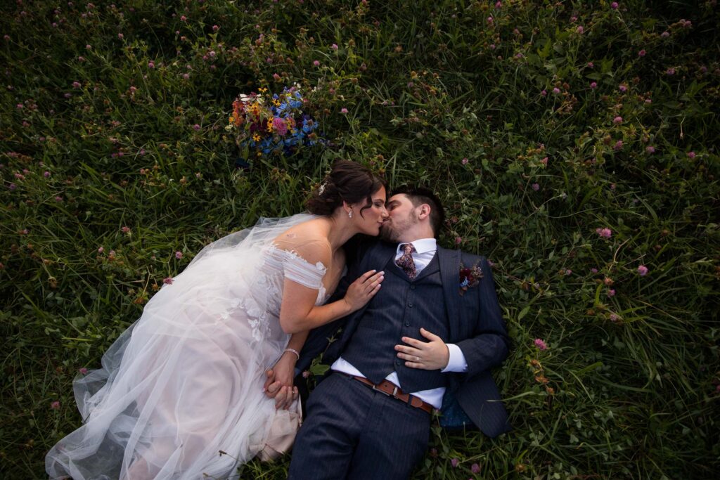 couple kissing in the grass on their wedding day in nc