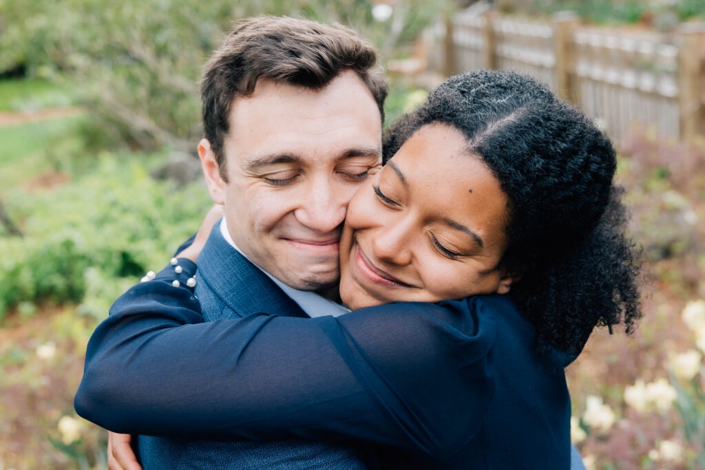 couple embraces a the unc arboretum in asheville, north carolina, after their surprise proposal