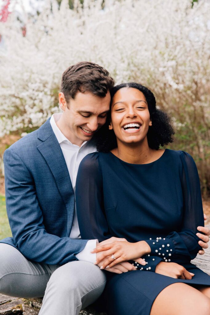 couple laughs after their proposal at the arboretum in asheville