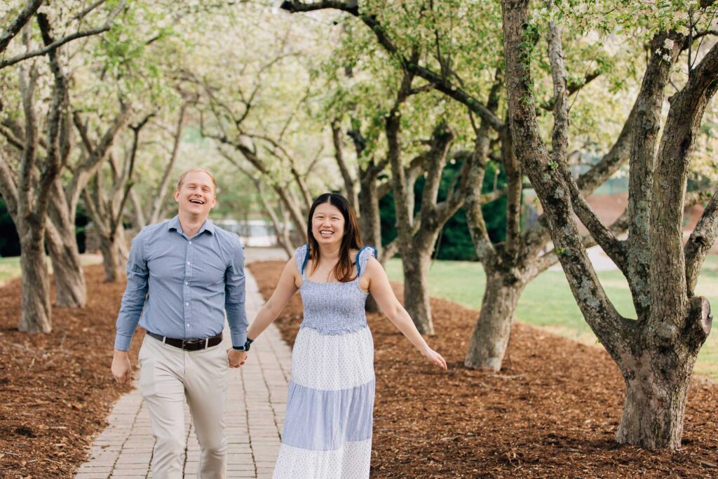 engaged couple walking along garden path after their proposal at the graylyn estate