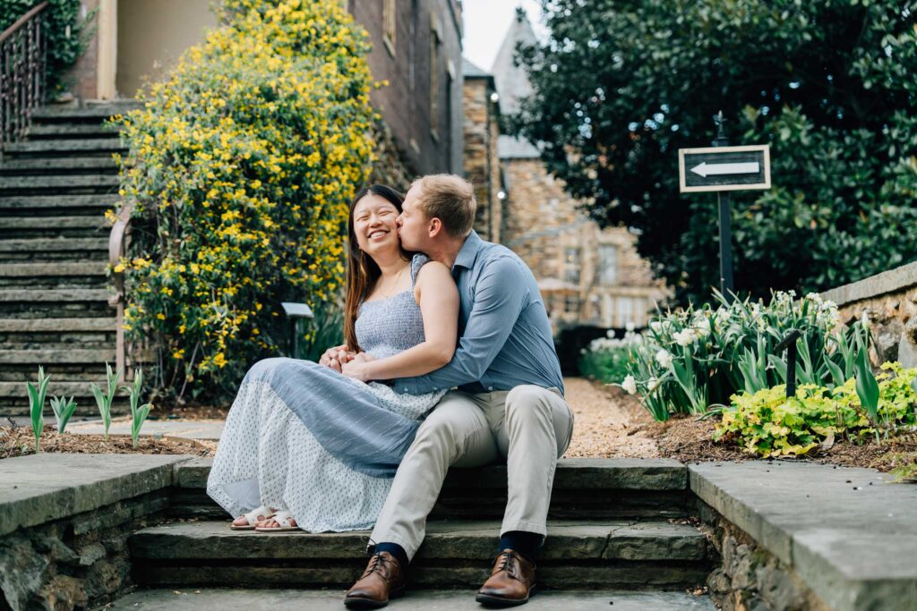 man kisses his fiancee after their proposal at the graylyn estate