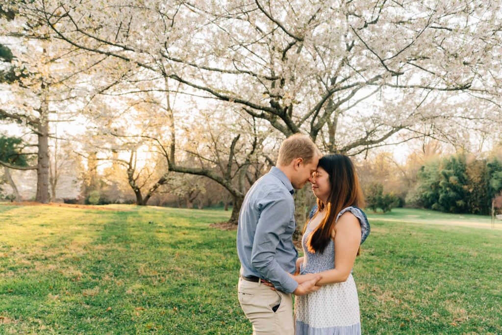 couple under cherry blossoms at the graylyn estate
