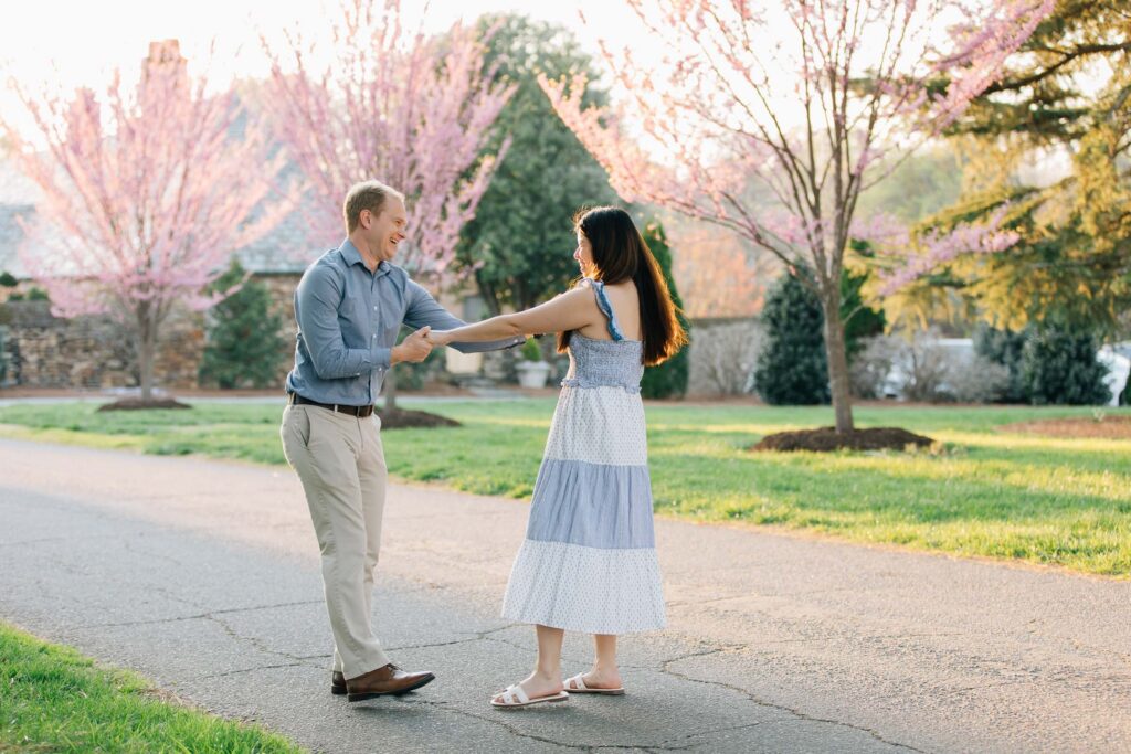 couple dances after their proposal in nc at the graylyn estate
