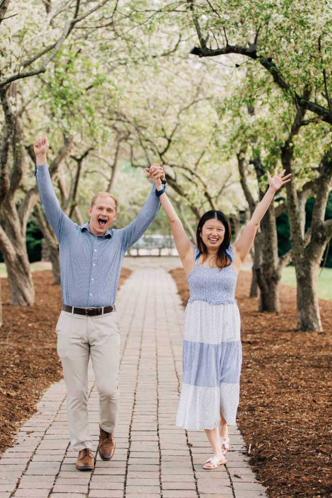 couple cheering after their engagement at the graylyn estate