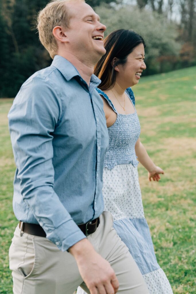 couple smiling and walking together after their marriage proposal at the graylyn estate