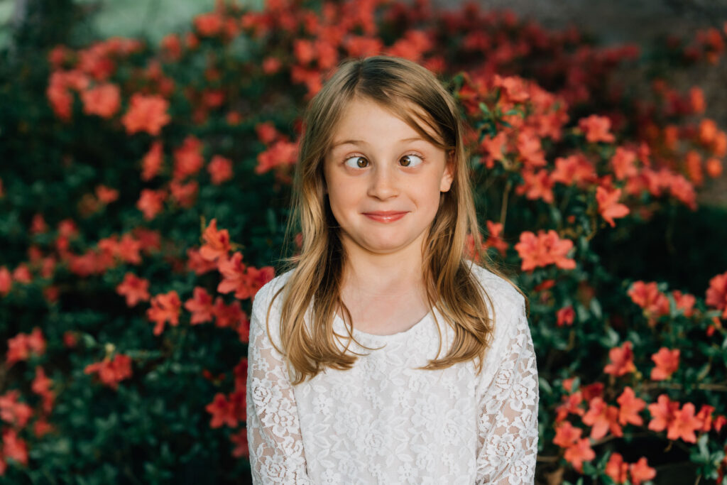 little girl crosses her eyes to be silly during a candid family session in salisbury nc