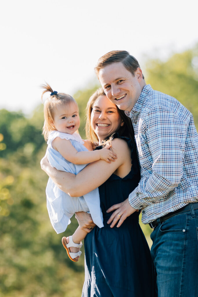 mom and dad cuddle their toddler at dogwood farms in belews creek nc