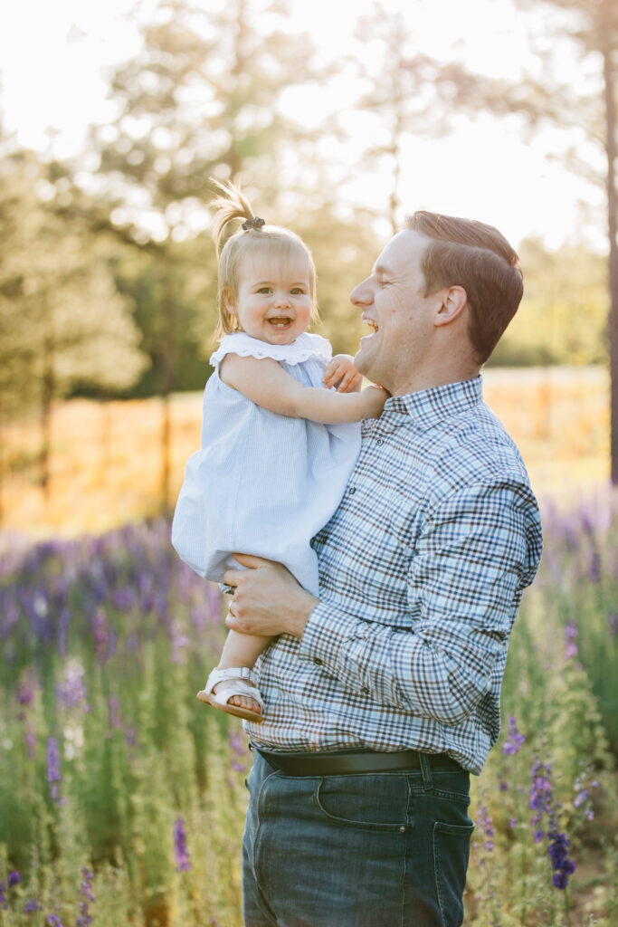 dad holds little girl at sunset at dogwood farms in nc