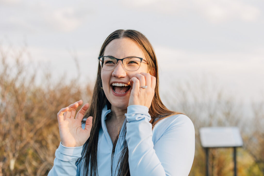 woman smiles and laughs after her boyfriend proposed to her 