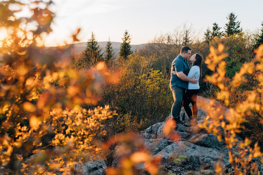 couple kisses after their surprise proposal at Grayson Highlands State Park in Virginia