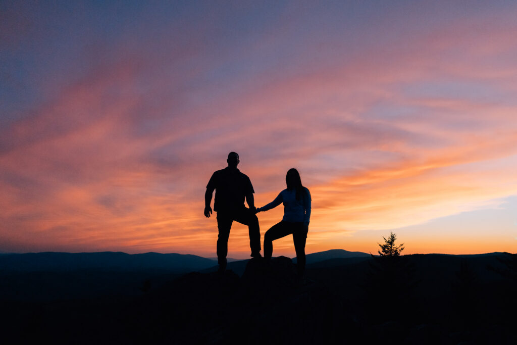 engaged couple silhouette with a beautiful sunset at grayson highlands state park