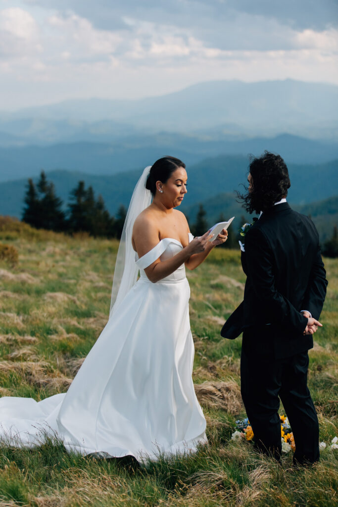 couple exchanging vows during their sunset elopement at roan mountain