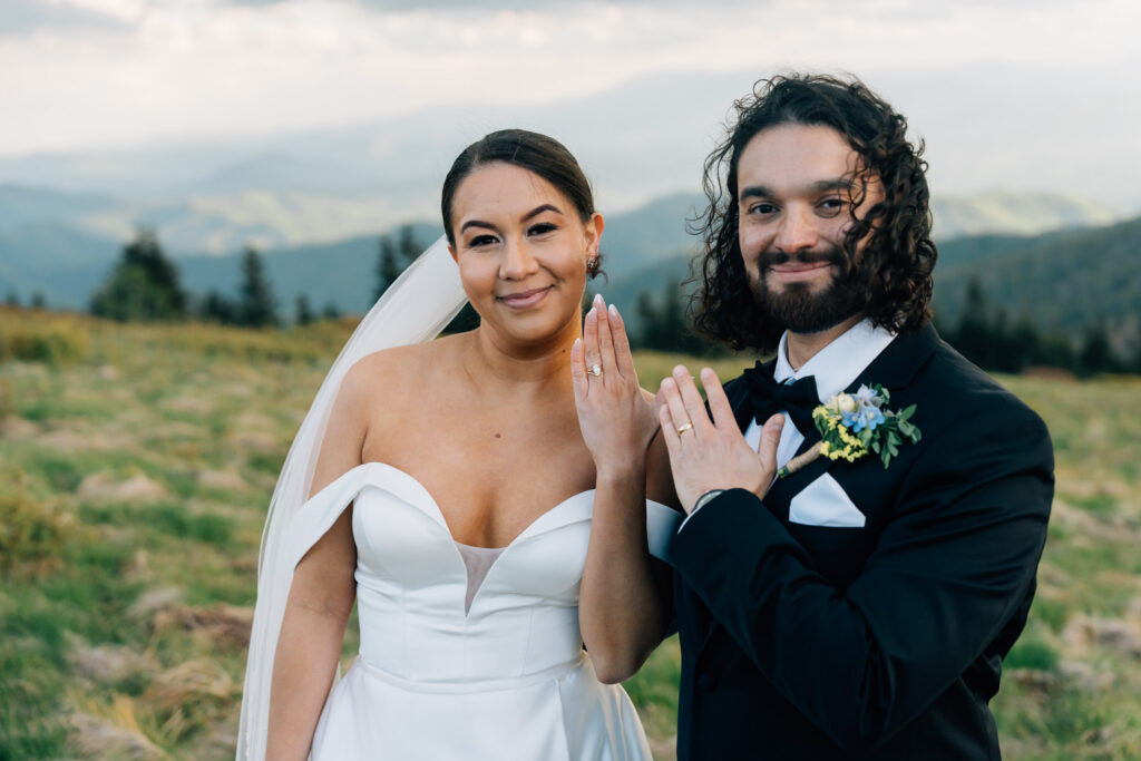 couple shows off their rings at their roan mountain elopement at carver's gap