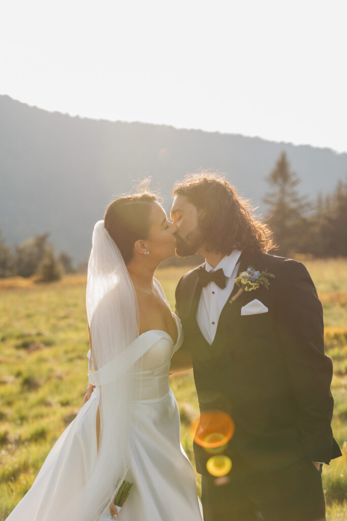 couple kisses in the golden sun at carver's gap during their elopement