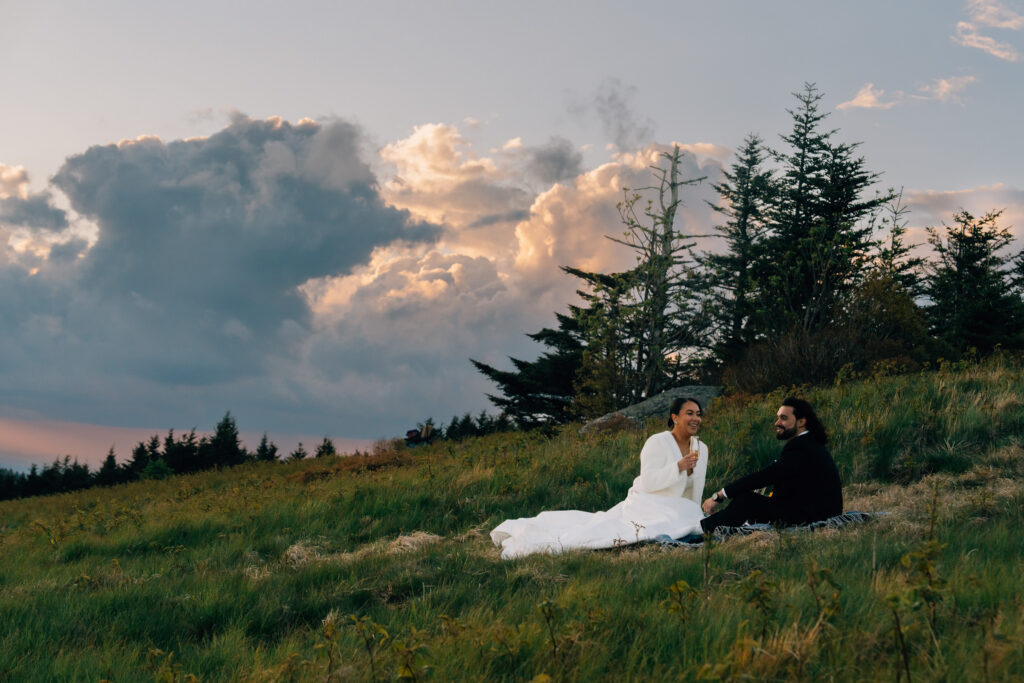 couple enjoys a picnic during their elopement at sunset in nc