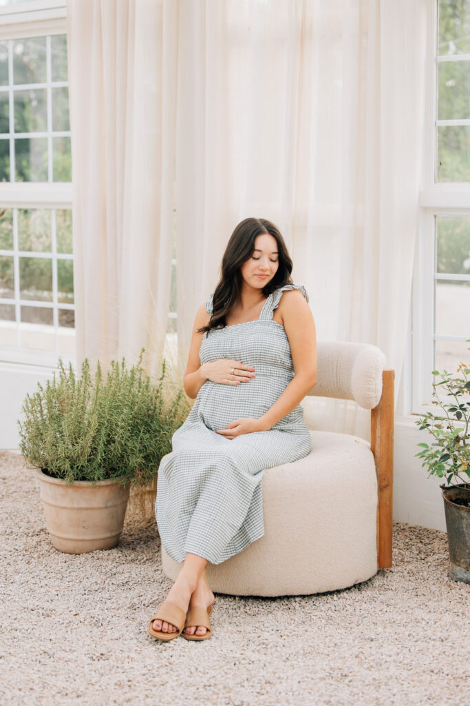 pregnant mom during summer maternity session at fleurish greenhouse