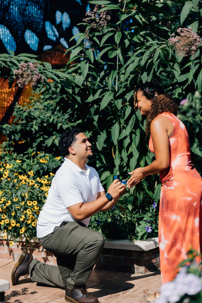 man proposing to his girlfriend at the greensboro science center