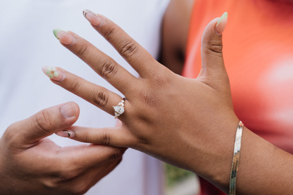 close up of engagement ring during surprise proposal at the greensboro science center