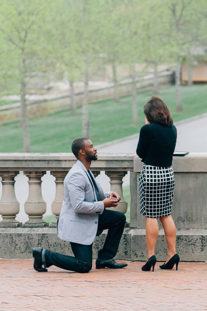 man down on one knee, proposing to his partner at the biltmore estate