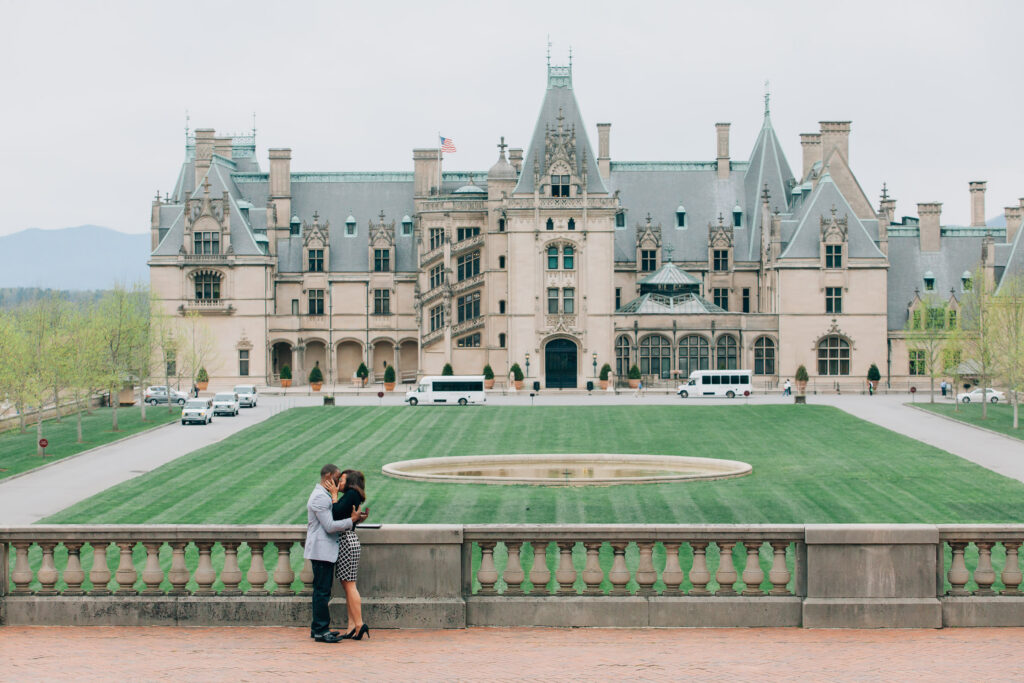 newly engaged couple hugs and celebrates during proposal at the biltmore estate