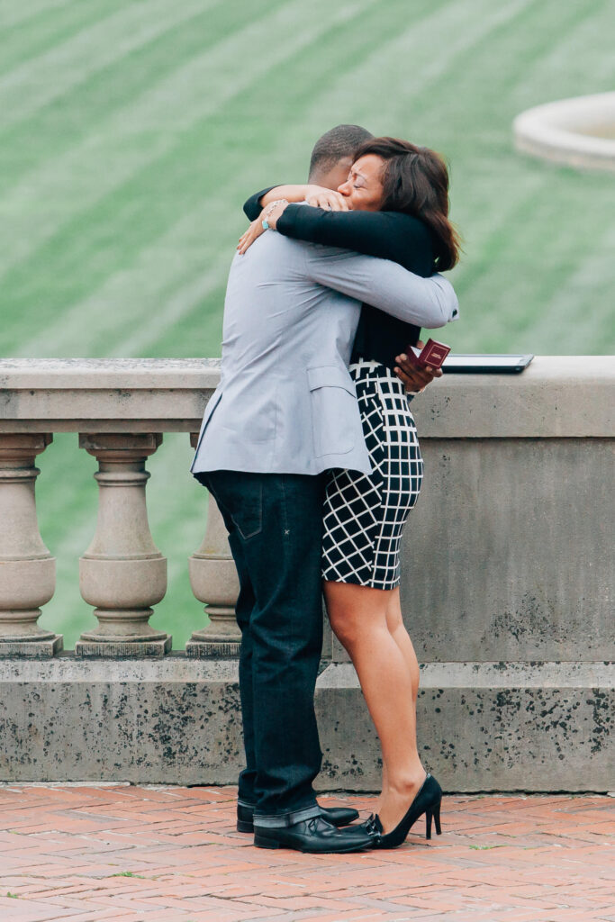 man hugs his fiancee right after he proposed to her