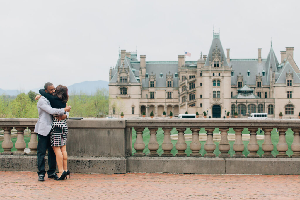 couple hugs after their proposal at the biltmore estate in asheville, north carolina