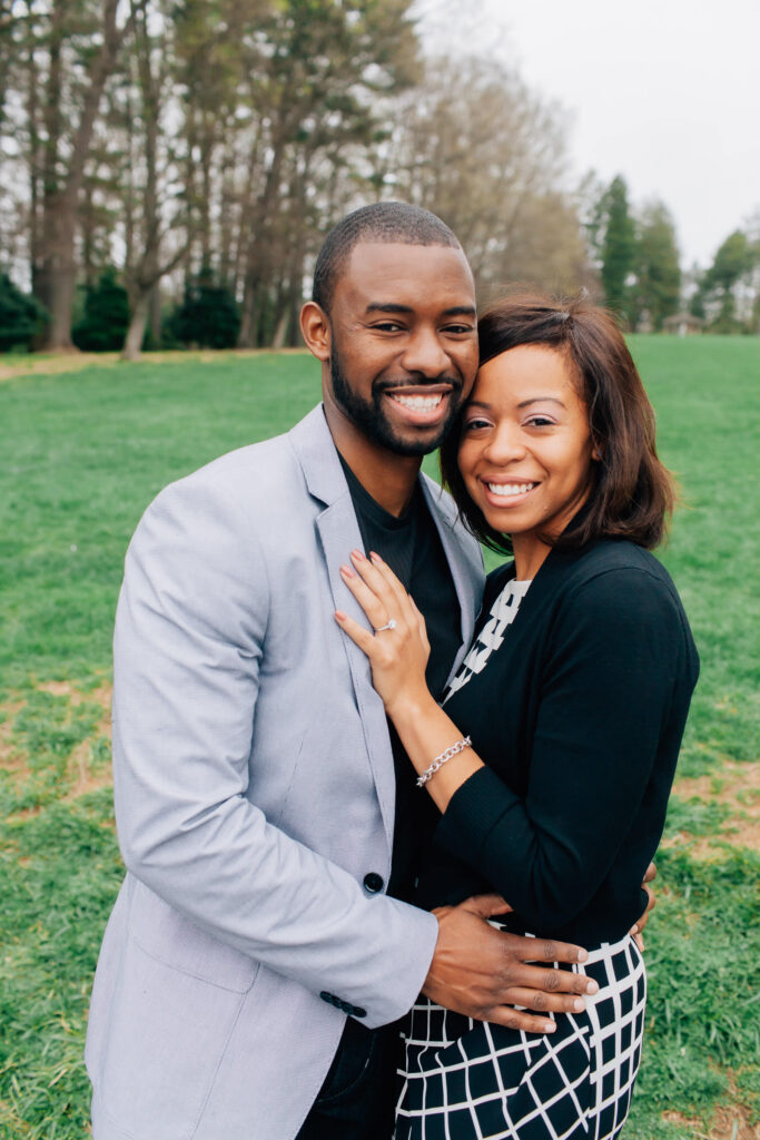 newly engaged couple smiles after their surprise proposal at the biltmore estate