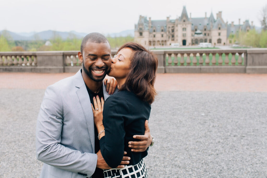 woman kisses her fiance's cheek after he proposed to her at the biltmore estate